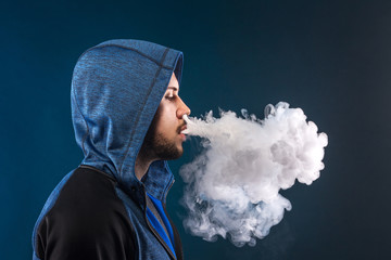 Vaping man and a cloud of vapor