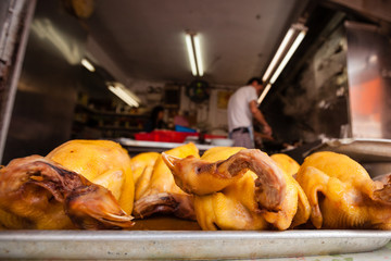 Roasted chicken on the plate. Asian street market.