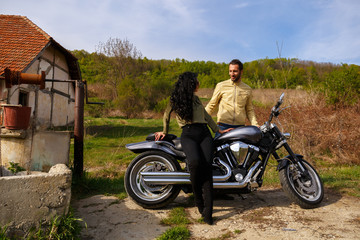 Plakat Beautiful young couple with a classic motorcycle