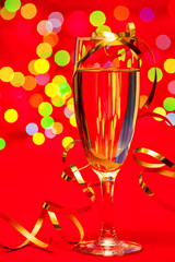 Glass of champagne with blurred lights in background