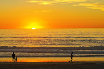 Fototapeta na wymiar People Silhouettes on Sunset Californian Beach