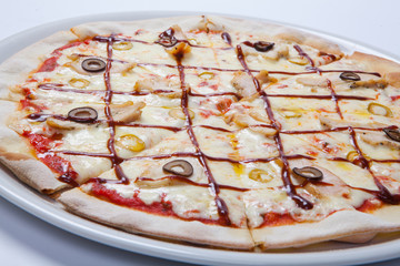Italian delicious pizza with olive, cheese and ham.