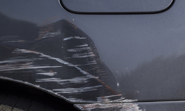 Car crash. Beside the dark grey color car have scratch from damage. Close up scratch	