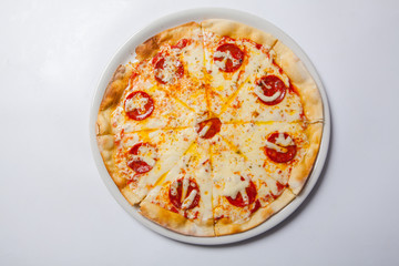 Tasty pizza with salami on white plate. White background
