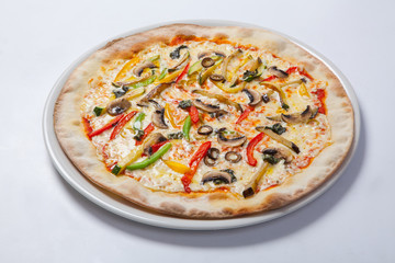 Fresh pizza with pepper, cheese and mushrooms on white plate