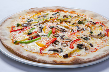 Fresh pizza with pepper, cheese and mushrooms on white plate