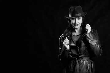 Fototapeta na wymiar Elegant fashionable woman wearing black coat and hat
