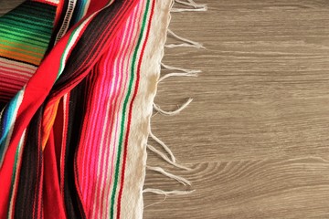 poncho Mexican cinco de mayo rug blanket serape fiesta traditional Mexico poncho background Mexican stripes copy space blanket minimal simple cinco de mayo serape pattern background  -  stock photo