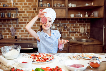 little girl having fun while making pizza