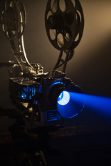 Vintage Film Projector with a blue beam from the lens
