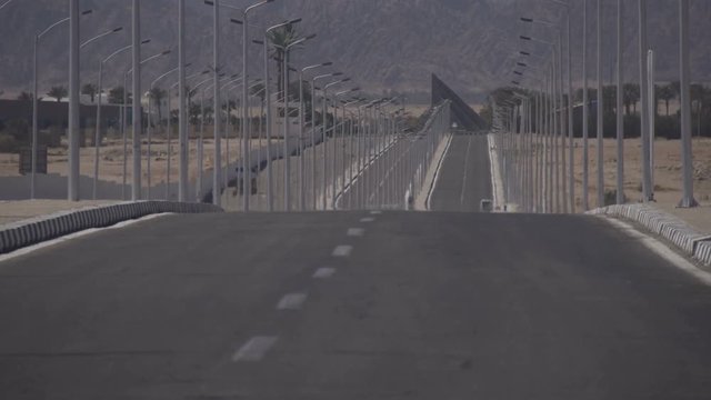 Lonely road near the desert mountains