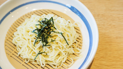 Zaru ramen (Japanese food) in a white bowl, soft focus.