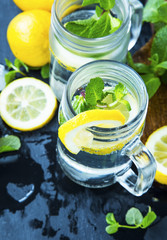 Lemon and mint infused water glasses.Fresh lemon slices with mint leaves