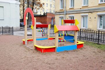 Fototapeta na wymiar children's playground in the yard of the old house