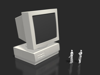 Two figures looking at the old-style desktop computer