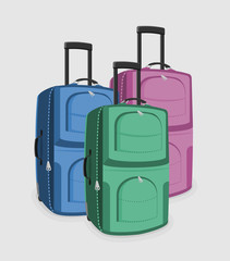 Three suitcases of green, pink and blue color isolated on a white background.