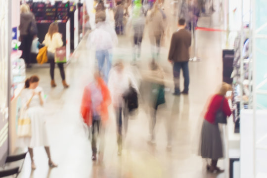 Abstract blurred image of shopping mall, people in a exhibition hall. For background , backdrop