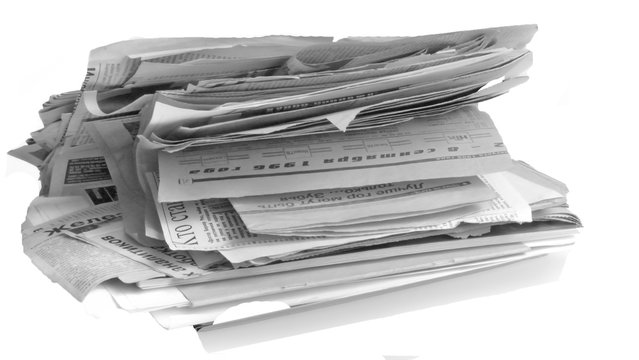 A stack of old newspapers isolated on white background
