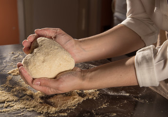 hands knead the dough