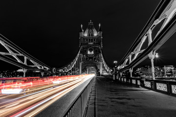 Fototapeta na wymiar Tower Bridge in London in black and white, UK at night with blur colored car lights.