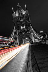 Tower Bridge in London in black and white, UK at night with blur colored car lights.