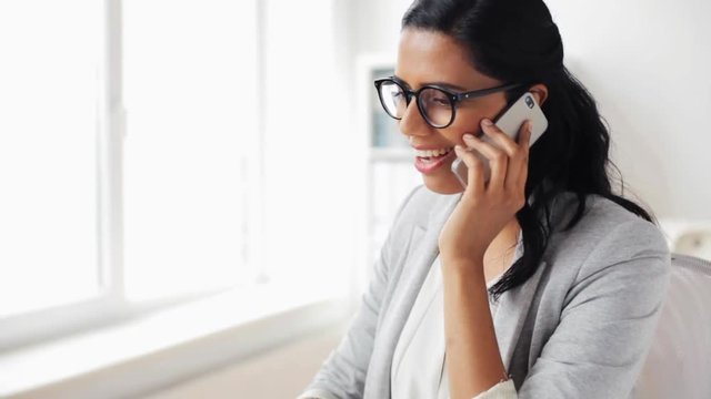 businesswoman calling on smartphone at office