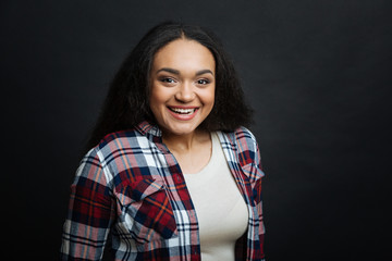 Charming Hispanic American woman smiling indoors