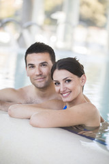 Young couple relaxing in thalassotherapy thermal water - obrazy, fototapety, plakaty