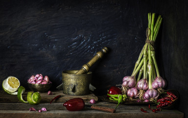 Classic still life with fresh vegetables placed with vintage copper pan on rustic wooden background
