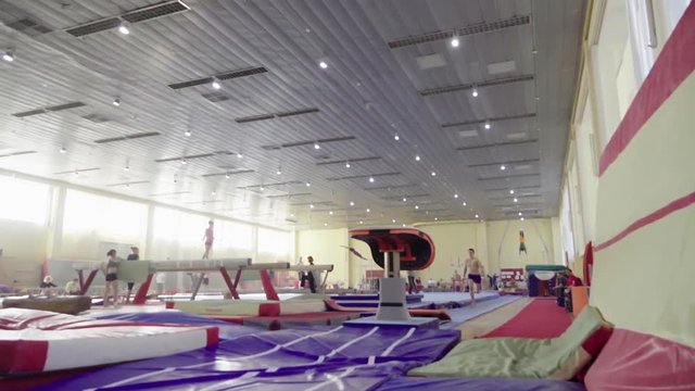 Gymnast training gymnastic somersault exercise HD slow-motion video. Athlete acrobatic vault performing: handspring, hand salto