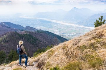 Fototapeta na wymiar Hiker looking from Monte Chiampon to Friuli-Venezia Giulia