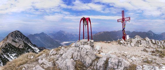 At the summit of Monte Chiampon with cross and bell