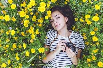 girl on the grass with camera