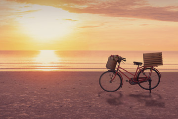 Bicycle on the beach with sunrise sky background, slow life concept