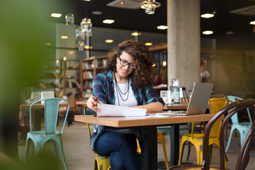 Modern businesswoman in city cafe.