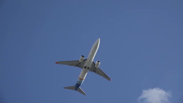 Aircraft flying on HD travel slow-motion video. Plane flight on blue clear sky