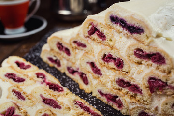 Cake with cream and cherries and cup of coffee,tasty cake with white cream,Russian cake named 