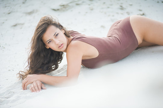 Fitness beautiful slim girl with brown hair posing