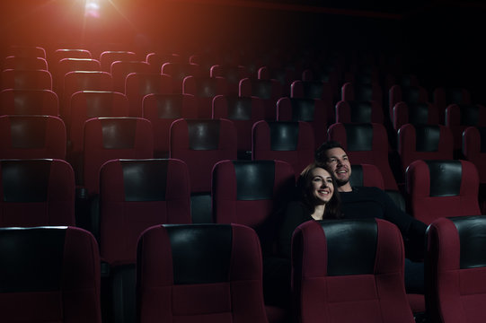 A Couple In Love Sitting In Empty Movie Theater