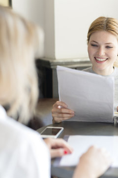 Smiling woman reading document