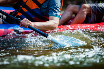 Focus some part of young person are rafting in river.