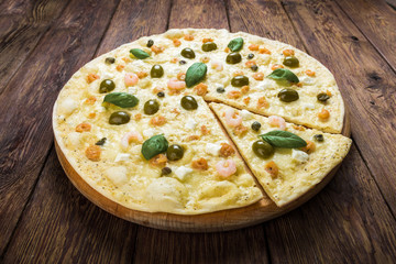 Italian seafood pizza at wood background