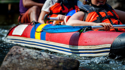 Focus some part of young person are rafting in river.