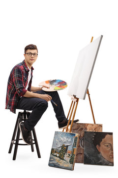 Teenage painter sitting in front of a blank canvas