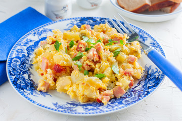 Traditional breakfast with potatoes, ham and eggs, horizontal