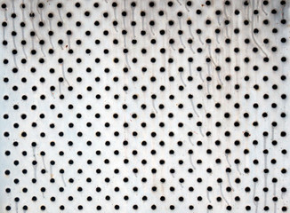 detail photography of rough metal plate with holes
