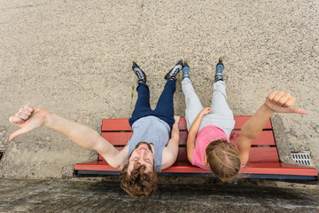 Young people friends relaxing on bench.