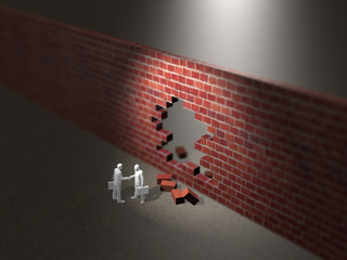 Business figures to shake hands in front of a hole with holes