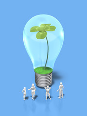 Family figures looking at the light bulb with four-leaf clovers