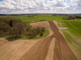 Aerial view of beautiful  agricultural fields and meadows in the german countryside. It is a clear, bright Spring day